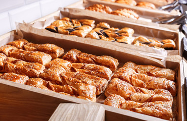 Various Puff pastry, Croissants, buns and pies on shelf in Bakery shop. Pastries and bread in a bakery