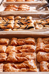 Various Puff pastry, Croissants, buns and pies on shelf in Bakery shop. Pastries and bread in a bakery