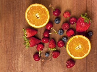 Bright oranges, strawberries, raspberries, blueberries and cherries