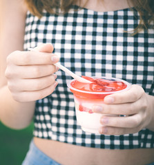 Young  girl eat dessert with strawberry .