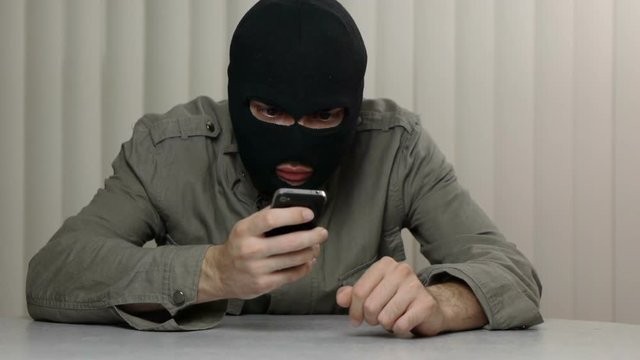 Hacker using a smartphone iPhone device that may be stolen. Great video for and project involving cyber criminality and thief
