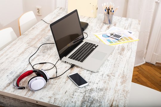 A Modern Home Office Setup On A Wooden Table..