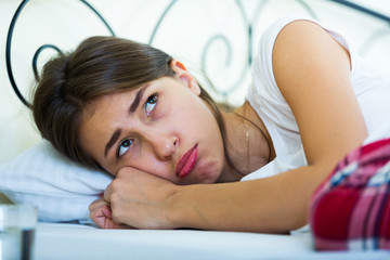 Obraz na płótnie Canvas Portrait of sad teenage girl in home bed