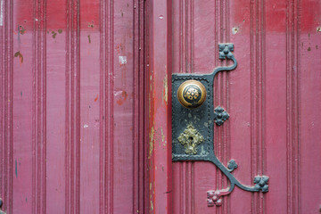 Old wooden church door with ornate metal lock door handle