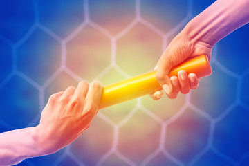 hands passing a relay baton on on soccer goal net background with vintage color tone effect.