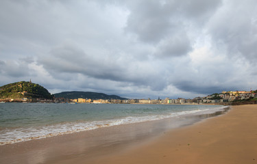 View of La Concha beach and city of San Sebastian in cloudy day, Basque Country, Spain
