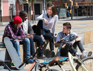 teens chatting near bikes