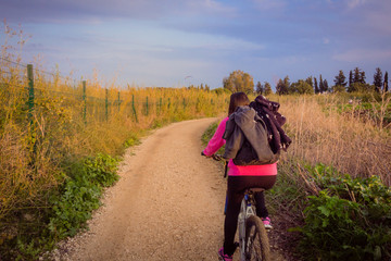 Fototapeta premium Woman riding a bicycle in the countryside