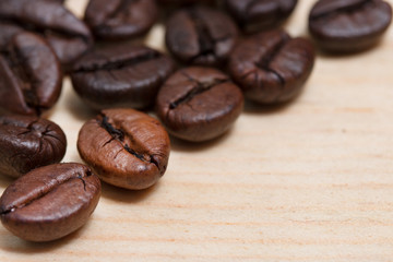 close-up coffee beans on wood table.