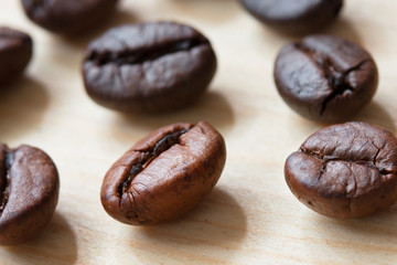 close-up coffee beans on wood table.