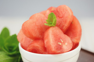 White bowl full of red hearts from the watermelon.