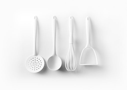 White Kitchen Tools Hanging On White Background