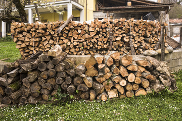 view of a rural country with close-up of a pile of wood
