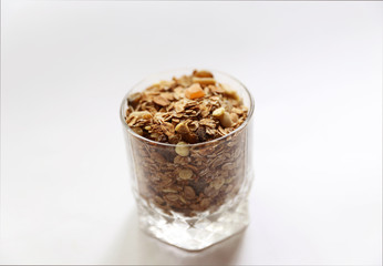 Granolai is for the breakfast in the transparent glass on white background