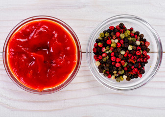 Ketchup, a Mix of Peppers on a Wood Board Background