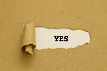 The word YES written under torn paper.