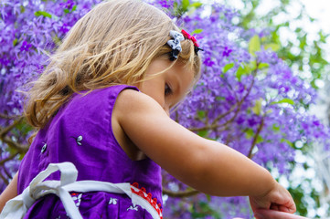 little girl on the background of purple wood