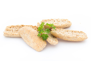Dry flat bread crisps with herbs on a white background.