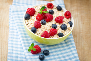 Oatmeal porridge with berries. Raspberries and blueberries.