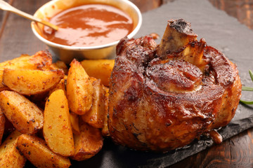 Grilled barbecue meat with baked potato and dip