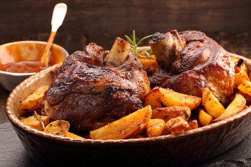 Grilled barbecue meat with baked potato and dip