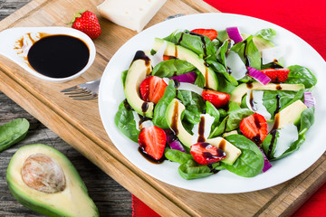 Strawberry,  baby spinach, red onion,  goat cheese and avocado s