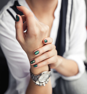 Beautiful modern fashionable girl with a green manicure. Nails style, gel.