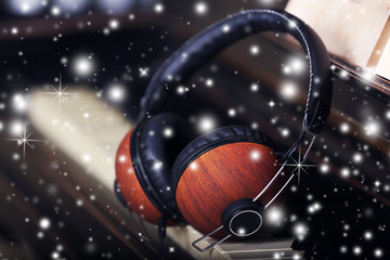 Brown headphones on piano keyboard with snow effect