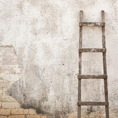 weathered stucco wall with wooden ladder background - 111891343