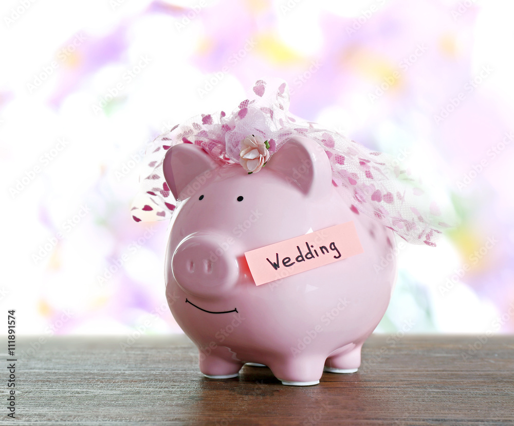 Poster piggy bank with wedding veil blurred festive background