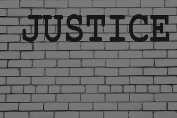 "Justice" text on brick wall