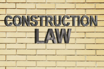 "Construction Law" text on brick wall