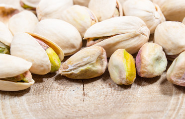 Pistachios on wood background.
