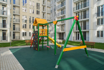 Fototapeta na wymiar The courtyard with a playground. The new apartment house.