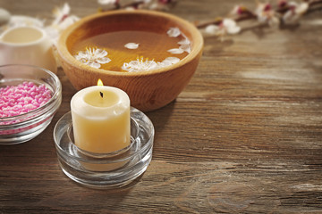 Spa composition with blooming branches on wooden table