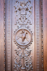 Eagle engraved on the wooden portal of an ancient church.