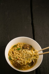 Asian quick noodles on wood with focus and blur background photo