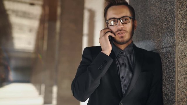 portrait of young successful business man having cell telephone