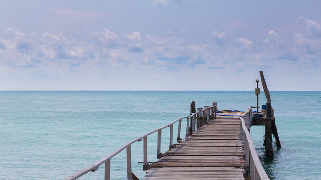 Wooden walkway path leading to the sea, natural skyline landscape background
