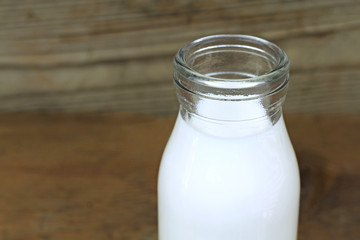 Milk and old style bottle on wood table