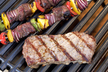 Barbecue. Grilled steak, shish kebab and grilled peppers, onion, on hot grill