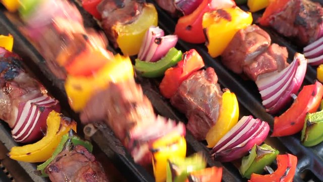 Barbecue. Shish kebab with grilled peppers and onion, on hot grill