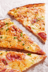 Tasty pizza on paper close up