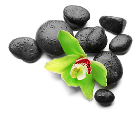 Fototapeta na wymiar Spa stones and green orchid isolated on white