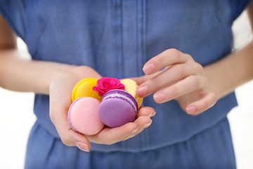 Woman holding macaroons, closeup