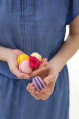 Woman holding macaroons, closeup