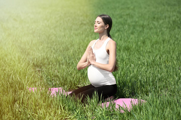 Pregnant woman practicing yoga pose