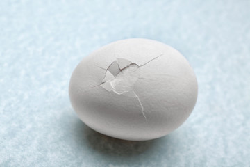 Cracked egg on grey background