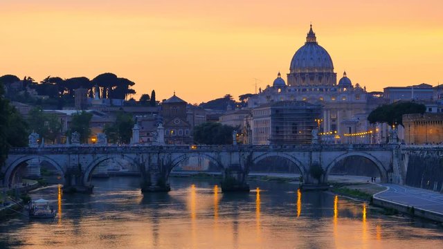 famous landmark st.peter basilica and sant'angelo bridge at the sunset reflection on tiber river rome italy
