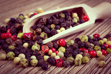 Vintage photo, Fresh colored pepper with spoon on wooden background